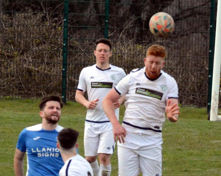 Fishguard Sports skipper Patrick Hughes wins this aerial battle